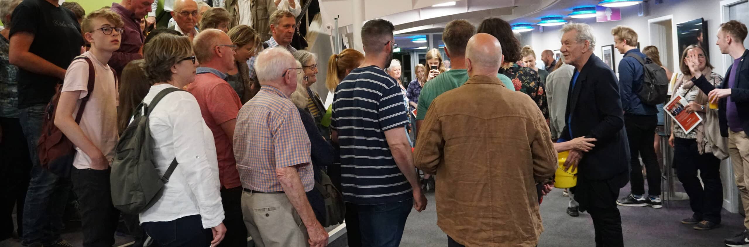 Photo of Sir Ian McKellan greeting people in the Northcott foyer
