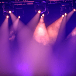 Stage lights shining through smoke
