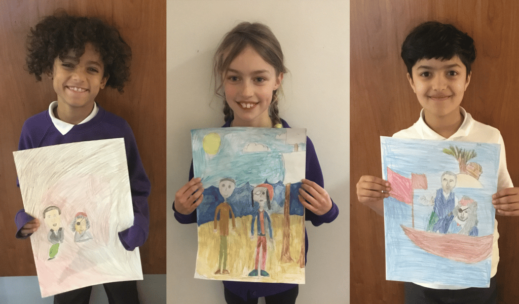 Three year 4 and 5 students, proudly showing their Treasure Island drawings