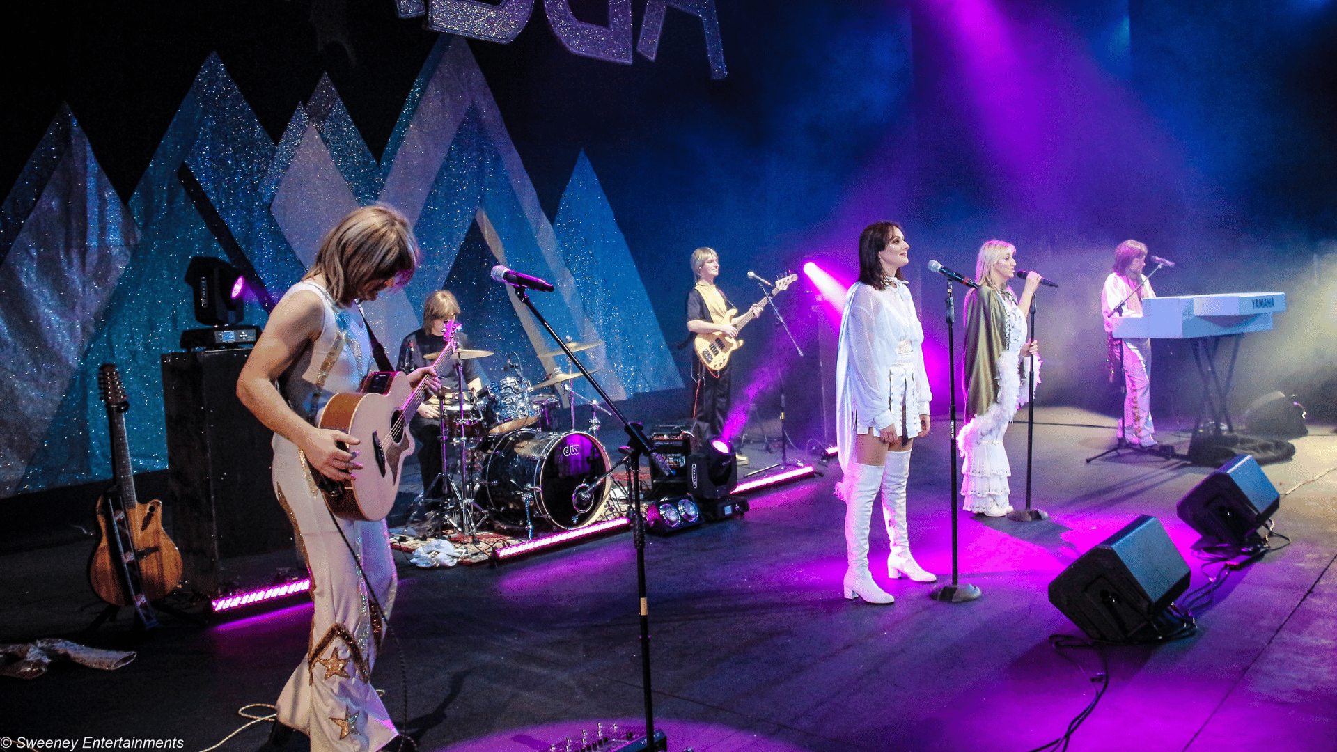 ABBA tribute band on stage singing