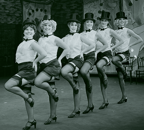 Archive image of Guys and Dolls - a line of women dancing, including a young Celia Imrie and Imelda Staunton
