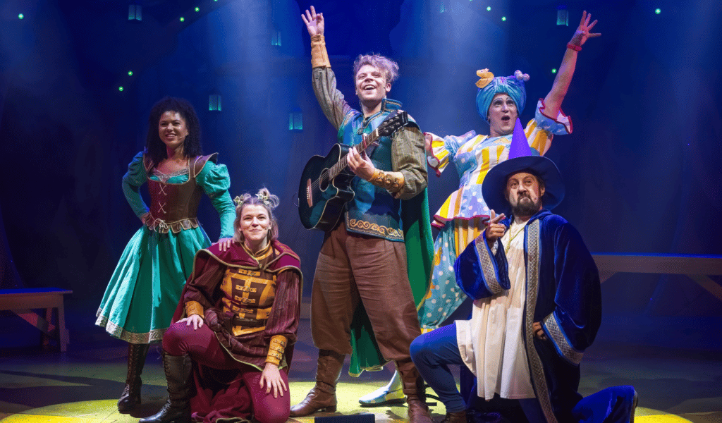 The heroic characters from Robin Hood facing forwards in triumphant poses. From left to right: Samara Rawlins (Marion), Victoria Boyce (Bluebell), Matthew Heywood (Robin), Matt Freeman (Nanny Fanny) and Nick Bunt (Merlin).