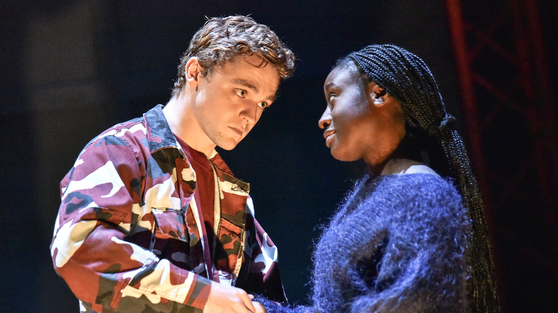 Noughts and Crosses production photo: (L-R) James Arden (Callum) looks into Effie Ansah's (Sephy) eyes as they hold hands