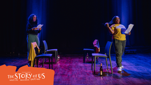Curation artwork: Two women stand at each side of a theatre stage, seperated by four chairs, each chair with a wine bottle and glass beside them. The two women are reading scripts; the woman on the right hand side of the image is throwing her hair back with her hand. Text reads: 'Encompass presents The Story of Us. અમારી કથા. Nasza Historia. हमारी कथा'.
