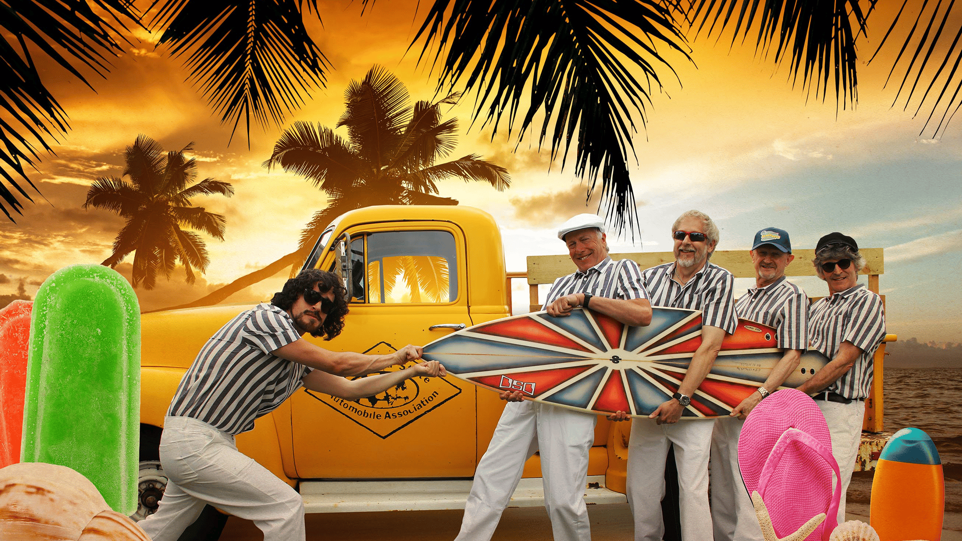 A man with black curly hair and sunglasses trying to pull a surf board from the arms of four other men. They are all wearing blue and white striped shirts and white trousers. They are in front of a yellow truck on a beach with lots of palm trees.