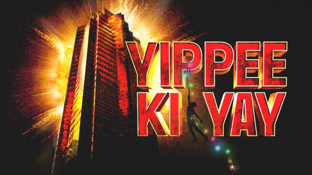 Text: YIPPEE KI YAY in big red capital letters. Behind, a big skyscraper, also red, surrounded by a golden light against an otherwise black background