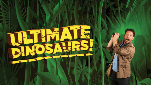 Ultimate Dinosaurs artwork - Ben Jarrod wearing a tan coloured shirt, holding a pair of binoculars in his hand and facing forward with his mouth wide open. Next to him the words 'Ultimate Dinosaurs!' appear in bold yellow lettering. The background is made of green jungle vines and leaves.