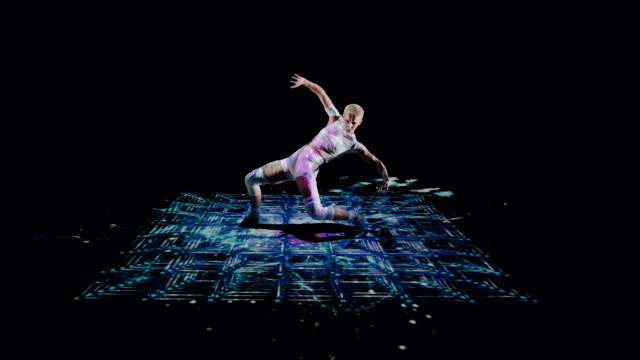 Tom Dale Company: Surge production photo - A photo of a dancer wearing a tight white outfit, bending low and leaning backwards in a pose. The floor is projected with futuristic lighting and the background is black.