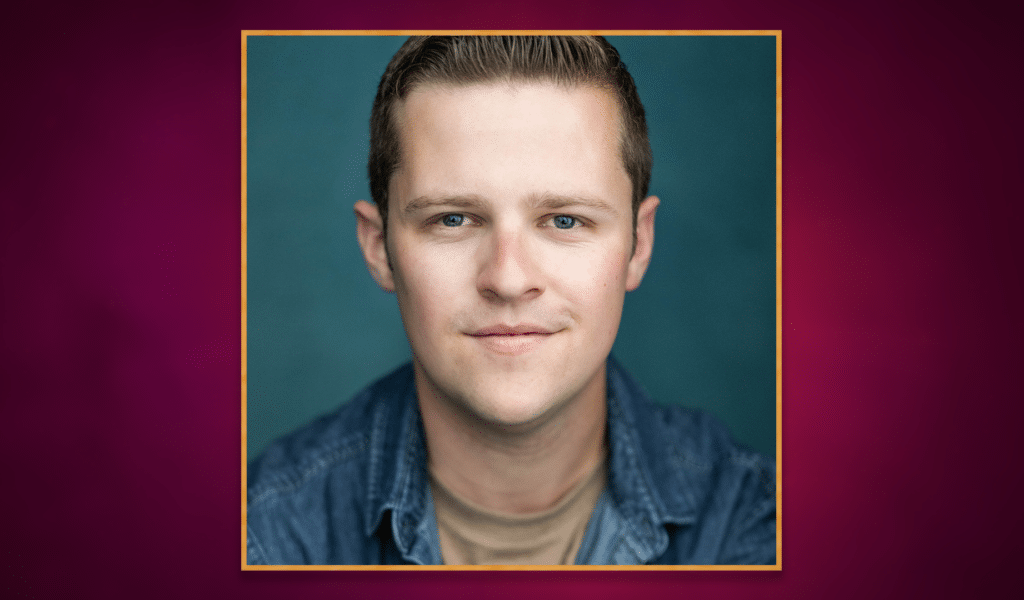 Headshot photo of actor Elliot Coombe, a young white man with light brown hair, wearing a light blue jacket and brown t-shirt. The headshot photo has a golden border around it, and is set on top of a purple gradient background.