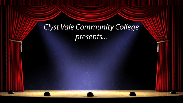 Illustration of an empty stage framed by red drapes and lit by two spotlights, with the text: Clyst Vale Community College presents...
