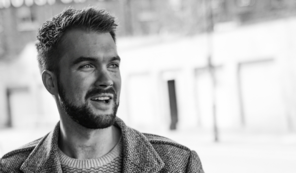 Black and white photo of Michael Betteridge, half-smiling at something off-camera.