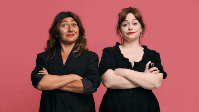 A photograph of Riona O Connor & Olga Thompson dressed in all black with their arms crossed.