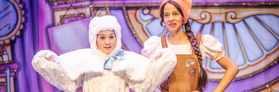 Photo of a child actor dressed as a white duckling beside Cinderella, dressed in rags.