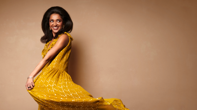 A photograph of Sindhu Vee in a yellow dress.