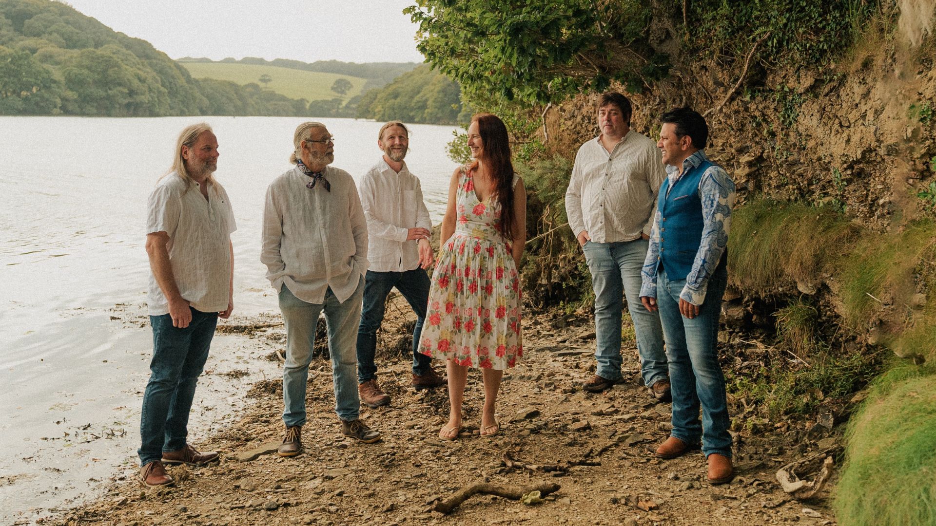 Image of The Gigspanner Big Band. 6 people stood together near a river.