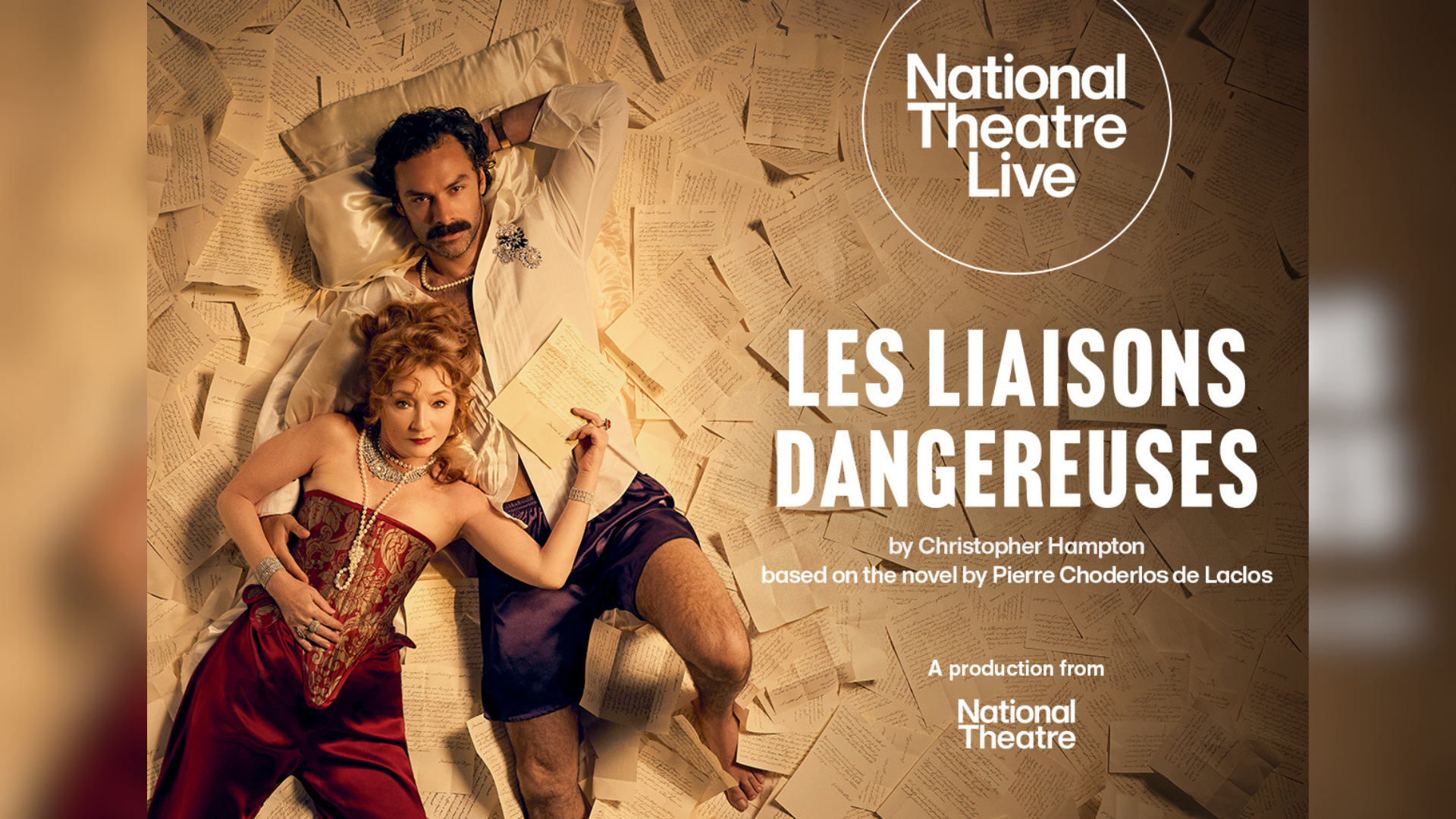 NT Live - Les Liaisons Dangereuses promotional artwork: a photograph of Lesley Manville and Aidan Turner lying on a floor covered in handwritten letters, staring seductively up at the viewer. Manville is wearing a red corset and silky trousers with pearl and diamond jewellery. Turner wears as unbuttoned white shirt with purple silk boxers and a pearl necklace. Text reads: 'National Theatre Live. Les Liaisons Dangereuses. By Christopher Hampton. Based on a novel by Pierre Chorderlos de Laclos. A production from National Theatre'.