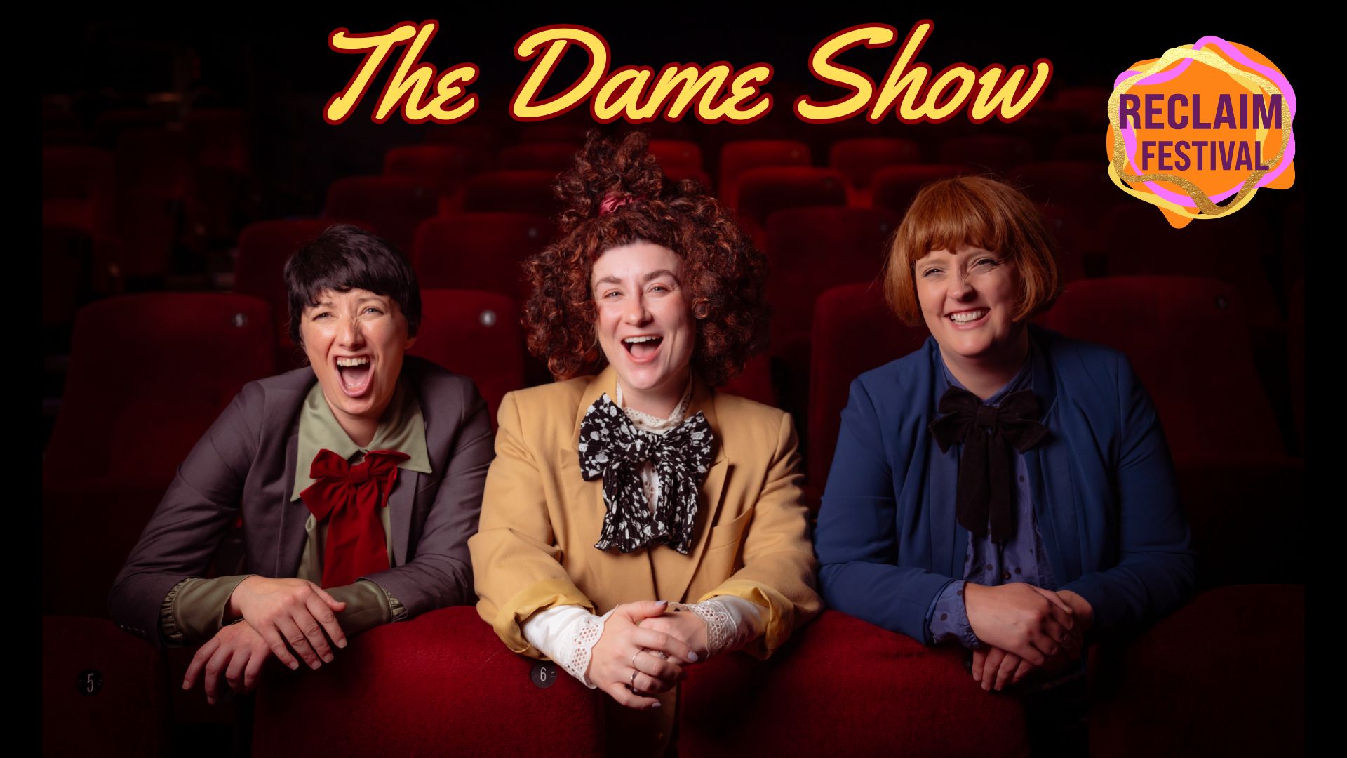 Three women popping up from behind a row of theatre seats. Each is wearing a wig and suits with large bow ties. Text reads: 'The Dame Show'. The top right corner of the image has the RECLAIM FESTIVAL logo.