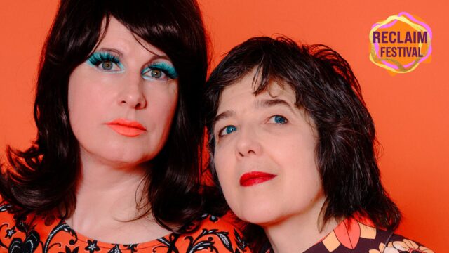 Washing Machine Vortex artwork. Two women dressed in 70s-style outfits pose together.