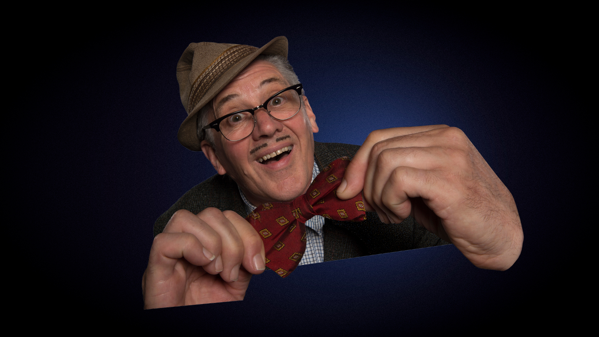 Count Arthur Strong in ‘And It’s Goodnight From Me!’ artwork. A cut out image of Count Arthur Strong smiling, adjusting his bowtie against a navy blue background.