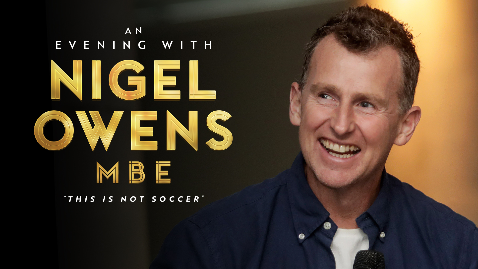A photo of Nigel Owens smiling. The text on the image says An Evening with Nigel Owens MBE - This is not soccer