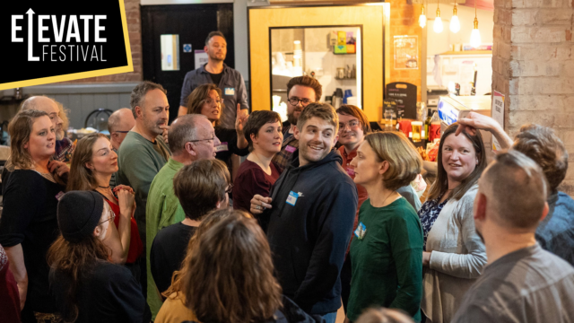 A photo of a group of people at the Barnfield Bar talking and laughing